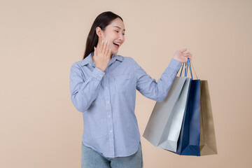 Joyful young woman holding shopping bags