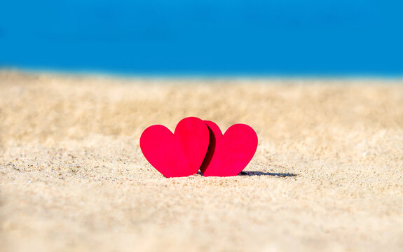 romantic symbol of two hearts on the beach
