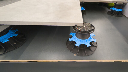 plots pavement grey tiles installation on house terrace with adjustable pads plastic