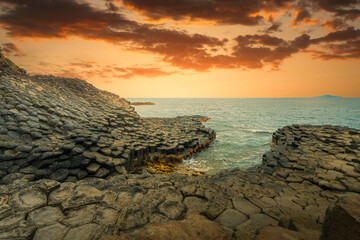 Obraz premium View of Ganh Da Dia or Da Dia Reef is a seashore area of uniformly interlocking basalt rock columns located along the coast in Tuy An town, Phu Yen Province, Vietnam