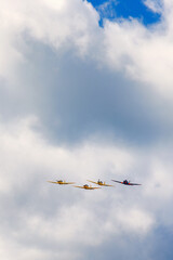 Group of airplanes in formation among the clouds
