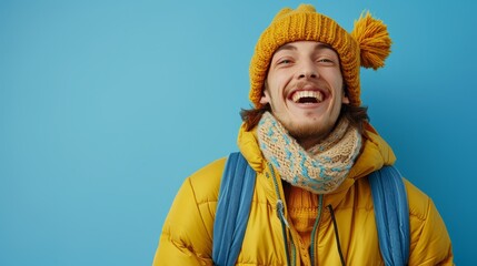 Obraz premium A man wears a yellow jacket, a blue and white scarf, and two yellow hats, one on his head and one around his neck