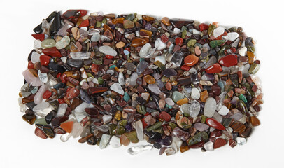 Heap of natural semiprecious stones isolated on white background. Texture of colorful gems