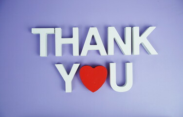 Thank You alphabet letters top view on purple background
