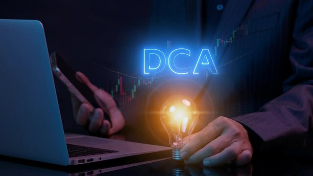 DCA, Dollar cost averaging concept. Investment strategy, Regular investment, Saving stock or savings on a monthly, quarterly basis. Businessman holding lightbulb to show DCA icon with investment graph