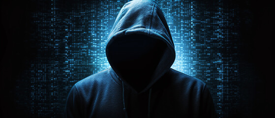 Silhouette of a hacker in a hood, technology background.