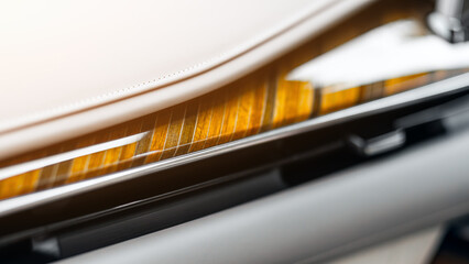 Close-up of a luxury car panel made of natural wood and leather