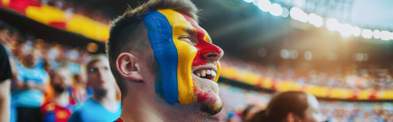 Happy Romanian male supporter with face painted in Romanian flag, Romanian male fan at a sports event