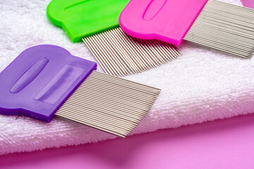 Three combs for removing lice and nits on lilac background
