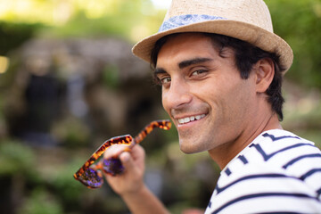 young attractive man in sunglasses in park