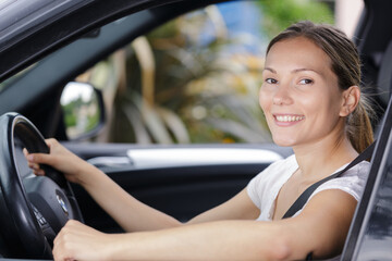 young female driver smiling on the camera