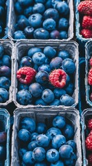 A blue and red fruit basket with blueberries and raspberries