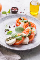 tomatoes with mozzarella with basil and pesto sauce