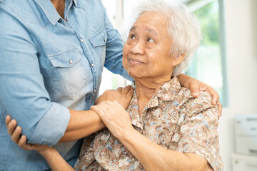 Caregiver help and care Asian senior woman patient with love, encourage and empathy in hospital.
