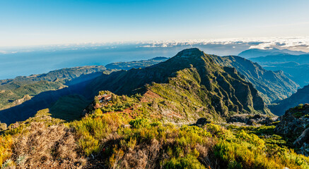 Hiking on the highest peak of Madeira Pico Ruivo next to the cottage Abrigo do Pico Ruivo. Views of...