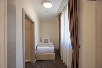 Very small single bed hotel room interior
