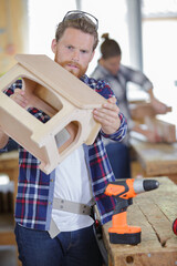 carpenter checking house model assemble