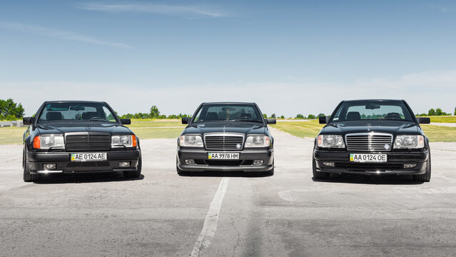 Three Mercedes-Benz E-class coupes C124 (W124) model. 1980s-1990s Mercedes cars on a sunny day at airfield. Kyiv oblast, Ukraine - June 02, 2018.