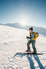 Mountaineer backcountry ski walking ski alpinist in the mountains. Ski touring in alpine landscape with snowy trees. Adventure winter sport. Low Tatras, slovakia
