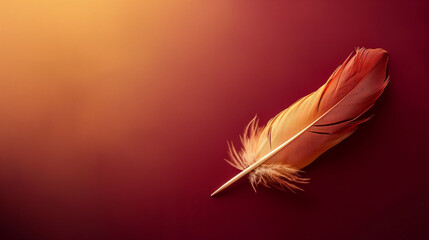 A feather quill pen elegantly placed on a rich burgundy-to-gold gradient background 
