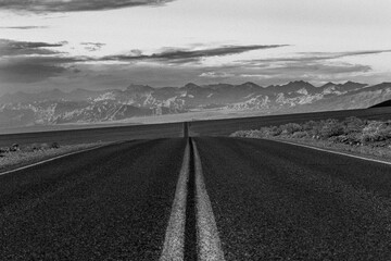 Paved road with mountains in the distance, Death Valley, California