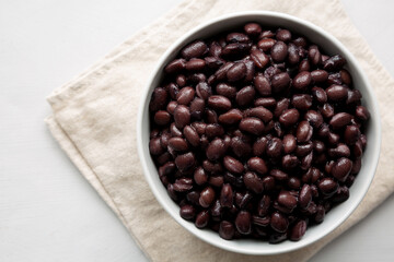 Homemade Preserved Black Beans in a Bowl, top view. Space for text.