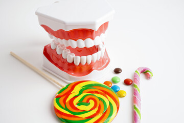Tooth decay with sweet sugar candy, bad food for dental health care.