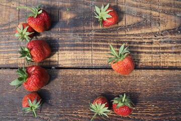 Strawberries on rustic wooden table, top view