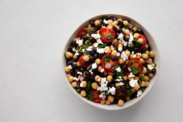 Homemade Chickpea And Black Bean Salad in a Bowl, top view. Copy space.