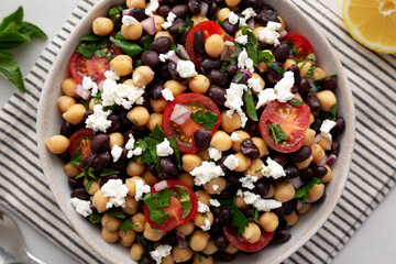 Homemade Chickpea And Black Bean Salad in a Bowl, top view. Close-up.
