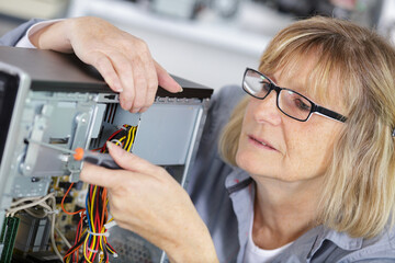 a female computer technician repairing pc