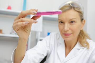 mature woman scientist looking at sample