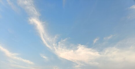 Vast Expanses of Cerulean Sky Adorned with Wisps of Delicate White Clouds, Stretched Like Gentle...