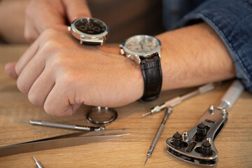 patient man repairing a watch cecking time