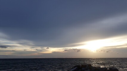 The Mesmerizing Golden Glow of the Setting Sun Gently Kissing the Endless Horizon, As the Tranquil Waves of the Ocean Embrace the Boundless Sky in an Eternal Dance of Nature’s Serene Beauty