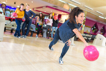 woman throwing ball in bowling club