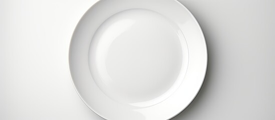A high quality photo featuring a white round plate placed on a white background with ample copy...