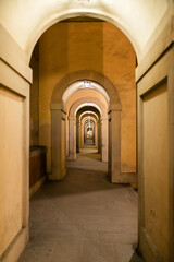 perspective view of a warmly lit archway corridor, creating a deep visual tunnel