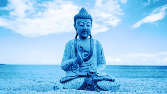 A buddha statue on a beach