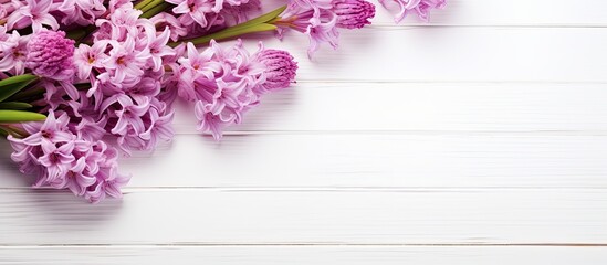 Hyacinth flowers on a white wooden background enhance the aesthetic appeal of beauty products in this copy space image