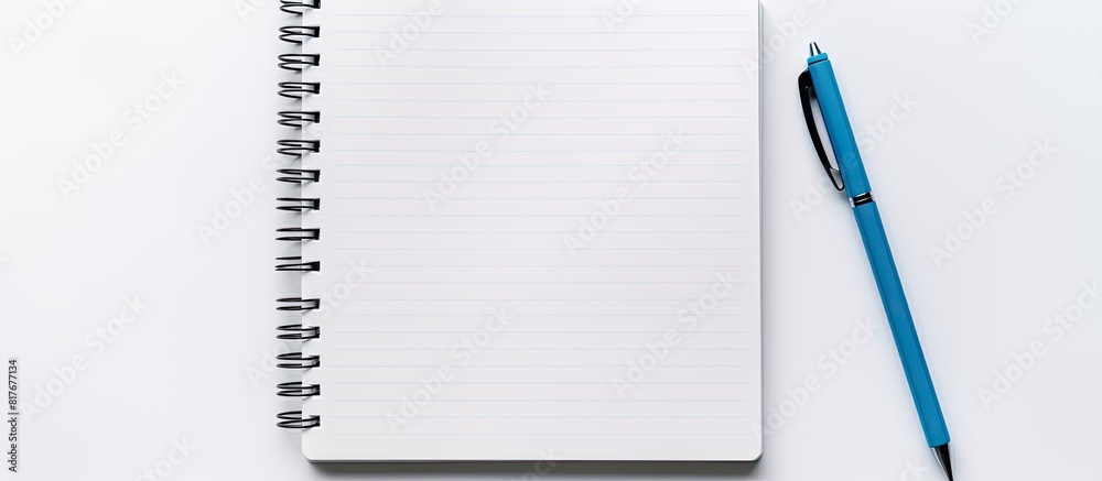 Aufkleber On a white background there is a white notepad with blank pages a notebook paper sheet and a blue pen Copy space image