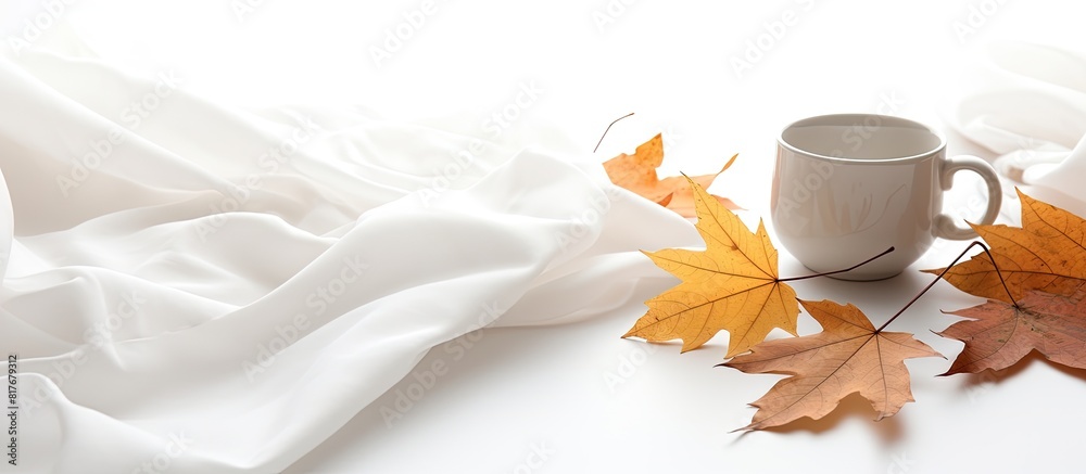 Poster autumn leaves on a white background complemented by a cup of coffee and a cozy green blanket copy sp