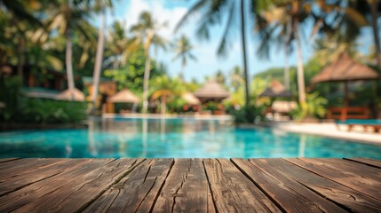 Fototapeta premium Image of wood table in front of swimming pool blur background. Brown wooden desk empty counter front view of the poolside on beautiful beach resort and outdoor spa.