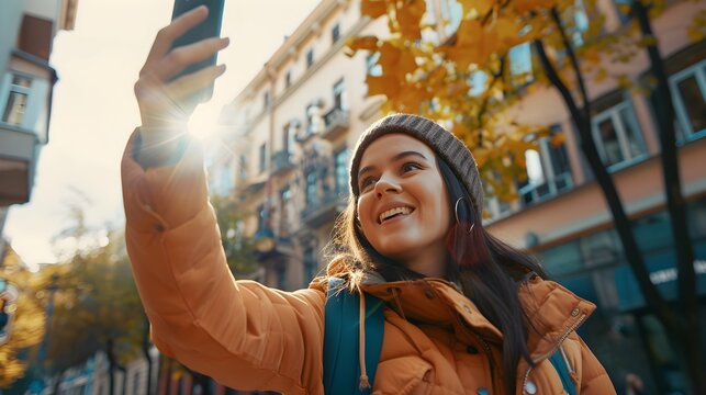 ugc of woman taking a selfie with her mobile phone outdoors