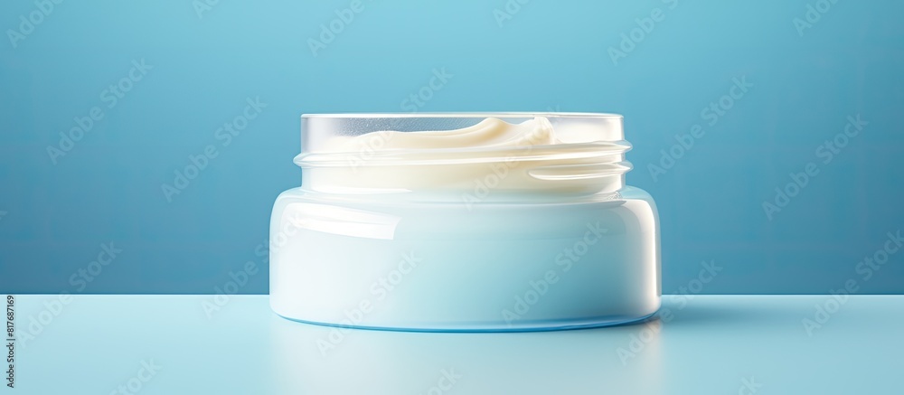 Aufkleber Closeup of an open tube of ointment on a light blue background providing ample copy space for text
