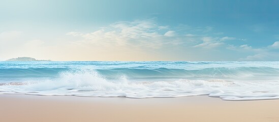 A gentle wave brushes against the sandy shore creating a serene summer background with enough room for a message. Creative banner. Copyspace image