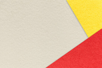 Fototapeta premium Texture of craft light beige color paper background with red and yellow border. Vintage abstract sand cardboard.