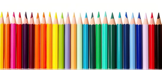 Obraz premium Colorful pencils create a blurred pattern isolated on a white background providing ample copy space image