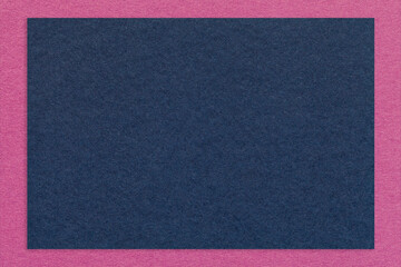 Fototapeta premium Texture of craft navy blue color paper background with purple border, macro. Vintage kraft denim cardboard