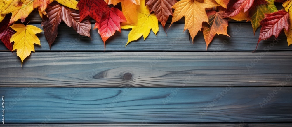 Poster there is a copy space image of colorful autumn leaves resting on a wooden table